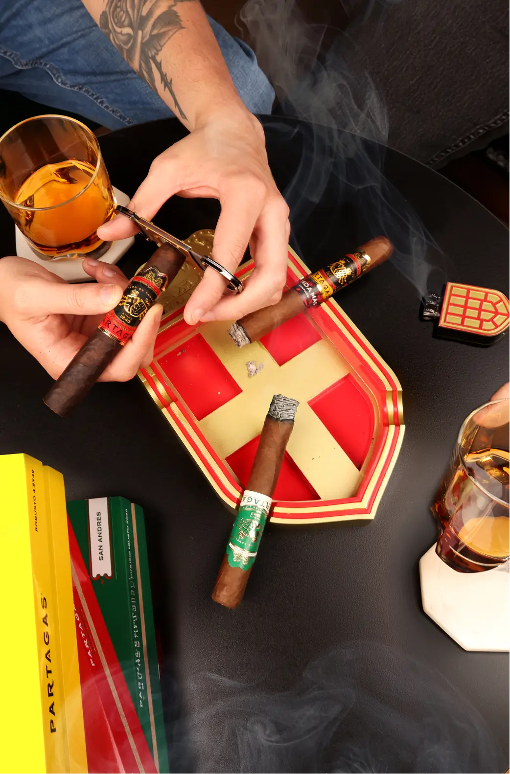 Partagas cigar ash tray and lit cigars